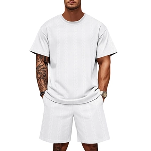 Close-up of men's white casual set showing intricate textured jacquard knit fabric detail