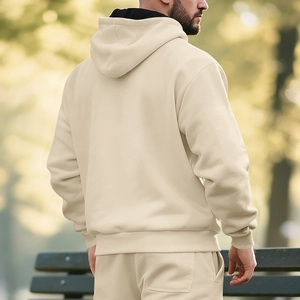 Outdoor view of beige hooded tracksuit with dropped shoulders and thick fleece material