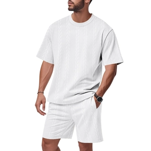 Detailed macro view of men's white jacquard two-piece set featuring textured wavy fabric