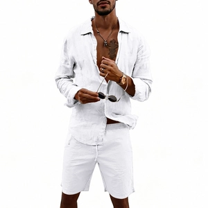 Detail of white linen set showing long sleeve shirt texture and drawstring shorts