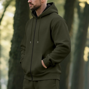 Detail of olive green fleece-lined zip-up hoodie set in a natural forest setting