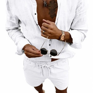 Close-up of white linen shirt and drawstring shorts featuring dark button details