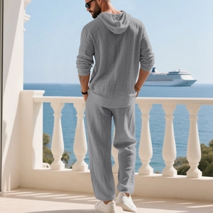 Men's grey linen casual set featuring hooded Henley top and loose trousers for vacation