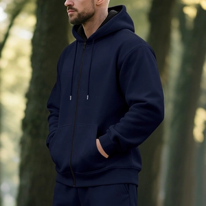Close-up of dark blue men's zip-up fleece hoodie featuring metal zipper and drawstring