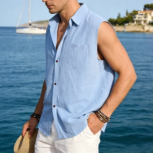 Close-up of light blue linen shirt featuring a classic collar and textured buttons