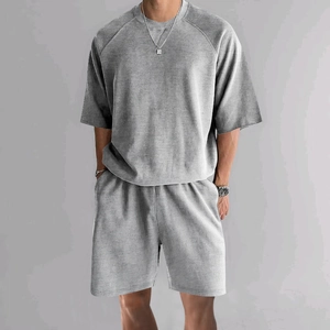 Close-up of light gray men's relaxed fit T-shirt and shorts set with waffle texture