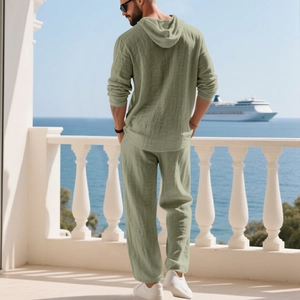Men's sage green linen hoodie set shown from the back on a balcony overlooking the ocean