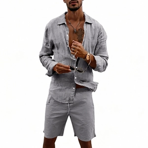 Detailed macro view of gray linen fabric texture on men's beach shirt and drawstring shorts
