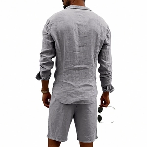 Detail view of the back of a grey linen shirt and shorts set with fabric texture