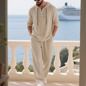 Detail of men's linen beach set showing beige textured fabric and hooded henley neck