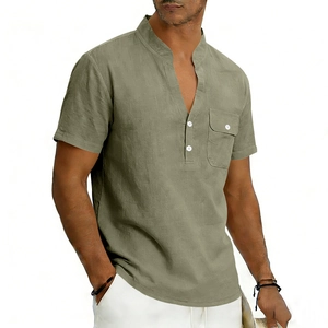 Detail of green linen Henley shirt featuring a stand collar, pocket, and button texture