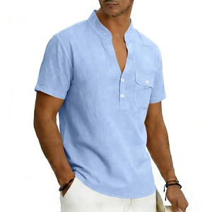 Detail of light blue linen shirt featuring a grandad collar and buttoned chest pocket