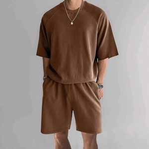 Detail of oversized dark brown cotton lounge set showing textured fabric and relaxed fit