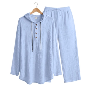 Detail of light blue linen blend set featuring wood buttons and drawstring hooded collar