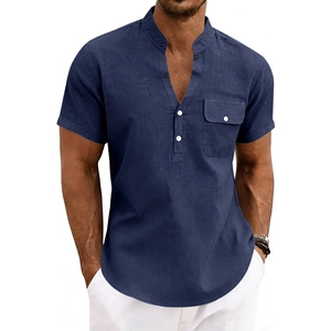 Detail of navy blue linen shirt showing the V-neck, white buttons and chest pocket texture
