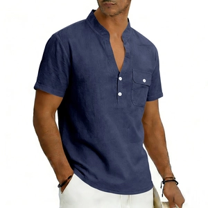 Detail of navy linen Henley shirt featuring standing collar and buttoned chest pocket