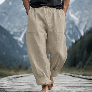 Detail view of men's linen pants with drawstring waist and large pockets in beige