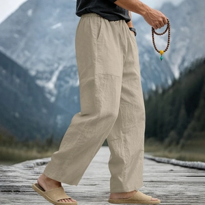 Close-up of khaki linen pants with elastic waist and natural texture on a boardwalk