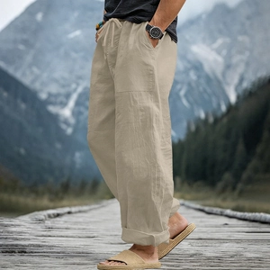 Detail of khaki linen pants featuring adjustable drawstring waist and side cargo pockets