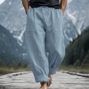 Detail of light blue linen trousers showing drawstring waist and large front pockets