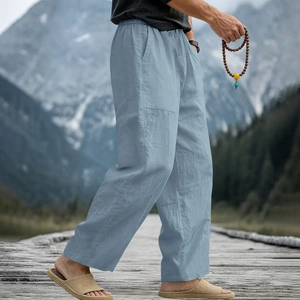 Detailed texture of light blue linen blend trousers for men with elastic drawstring waist