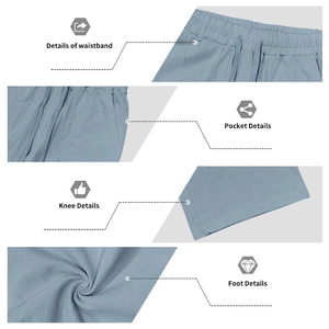 Detail view of light blue linen trousers with drawstring waist and pocket stitching