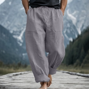 Detail of grey men's linen pants featuring drawstring waist and large front pockets