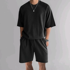 Close-up of the waffle texture fabric on this black men's casual summer two-piece set