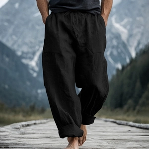 Detail of men's black linen loose pants featuring drawstring waist and large side pockets