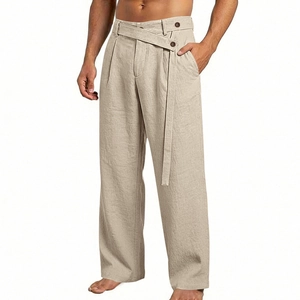 Detail of khaki linen pants featuring a unique crossover waistband and button closure
