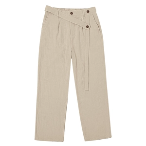 Detailed view of elastic waist on light khaki linen pants with decorative belt and buttons