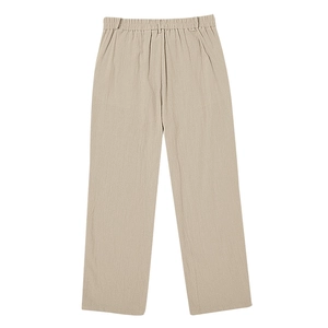 Detail view of men's casual beige linen trousers with elastic waistband and natural texture
