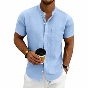 Detail of light blue linen shirt with stand collar, chest pocket and textured fabric
