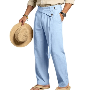 Detail of light blue linen trousers with cross-overlap waistband and button detail