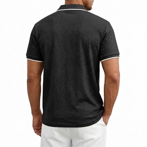 Detail view of men's black polo shirt showing herringbone jacquard texture and white piping