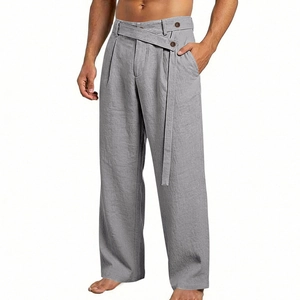 Detail of grey men's linen wide-leg trousers featuring unique overlapping waist buttons