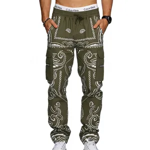 Detail view of olive green cargo pants with white paisley patterns and zipper pockets