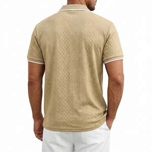 Detail of khaki knit polo shirt showing textured herringbone fabric and white striped cuffs
