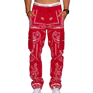 Detail view of red paisley cargo pants featuring side flap pockets and white drawstrings
