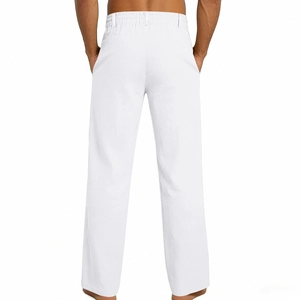 Macro view of white linen pants showing elastic waistband and belt loops detail