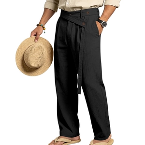 Detail of men's black linen pants featuring a unique cross-over waist with button closure