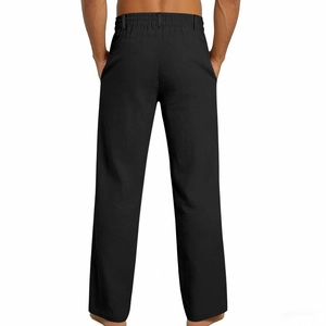 Detail of men's black linen pants showing elastic waist, belt loops and rear pocket