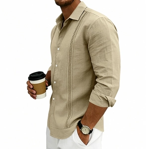 Detail view of khaki linen shirt featuring symmetrical hollow embroidered ribbon accents