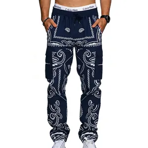 Detail view of navy paisley cargo pants showing drawstring waist and side zip pocket
