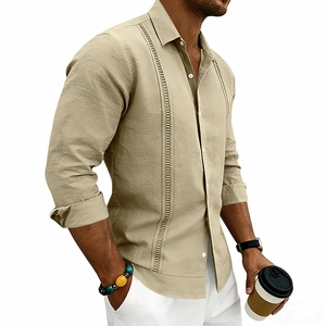 Detailed close-up of khaki linen shirt featuring hollow embroidery and white buttons