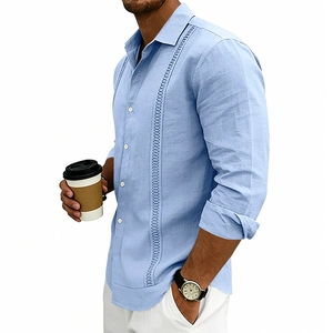 Detailed view of light blue linen Guayabera shirt with vertical embroidery and white buttons