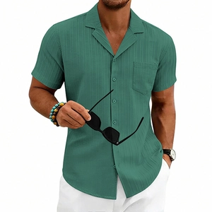 Detail of dark green men's Cuban collar shirt showing vertical stripe texture and chest pocket