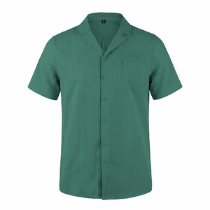 Detailed macro shot of the dark green vertical ribbed fabric and chest pocket of the shirt