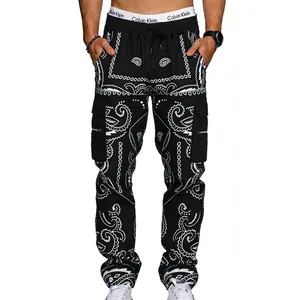 Detail of men's black paisley cargo pants featuring side flap pockets and white patterns