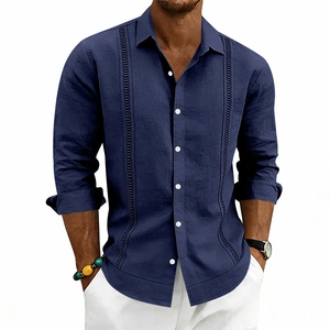 Detailed view of dark blue linen shirt with vertical embroidery and white buttons